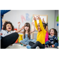 Preschoolers sitting in a circle smiling and playing